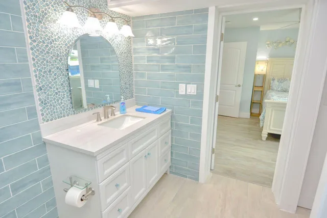 a bathroom with a sink vanity and a mirror