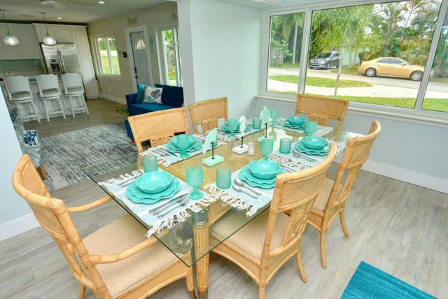 a view of a dining room with furniture a rug and wooden floor