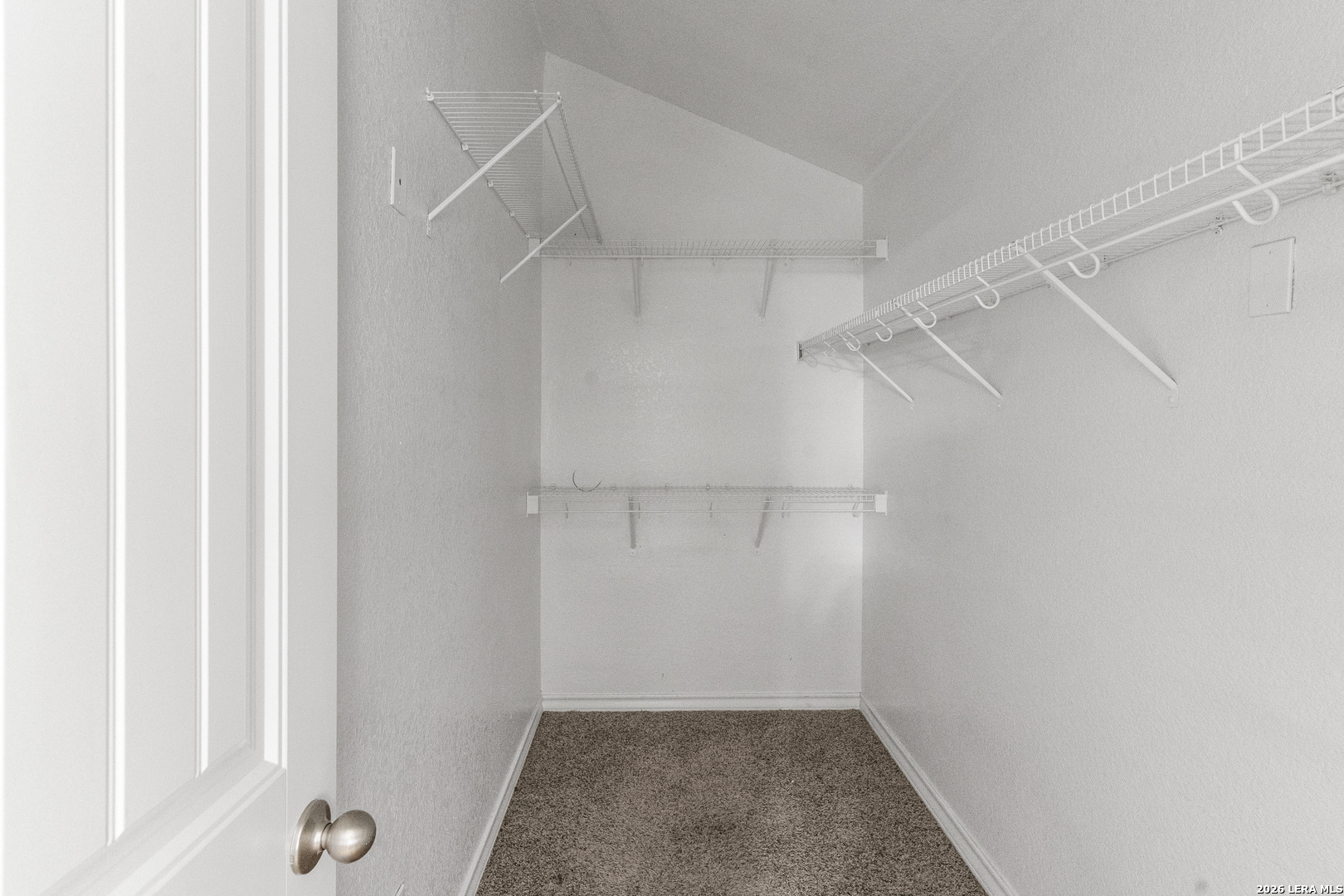 10421 Macarthur Way Converse, TX 78109 - Photo 19 of 26 a view of walk in closet with empty racks