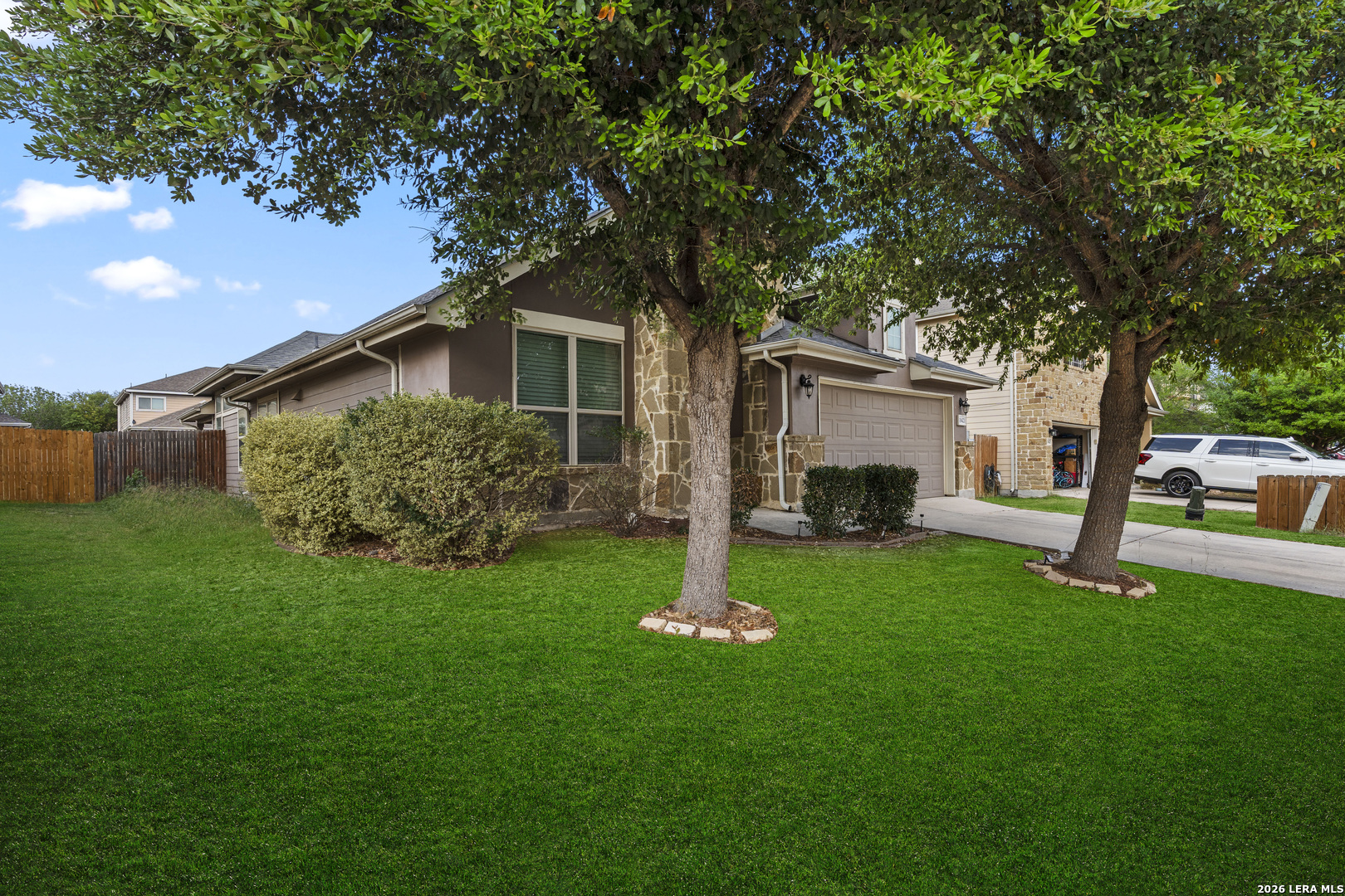 10421 Macarthur Way Converse, TX 78109 - Photo 3 of 26 a front view of a house with a garden and yard