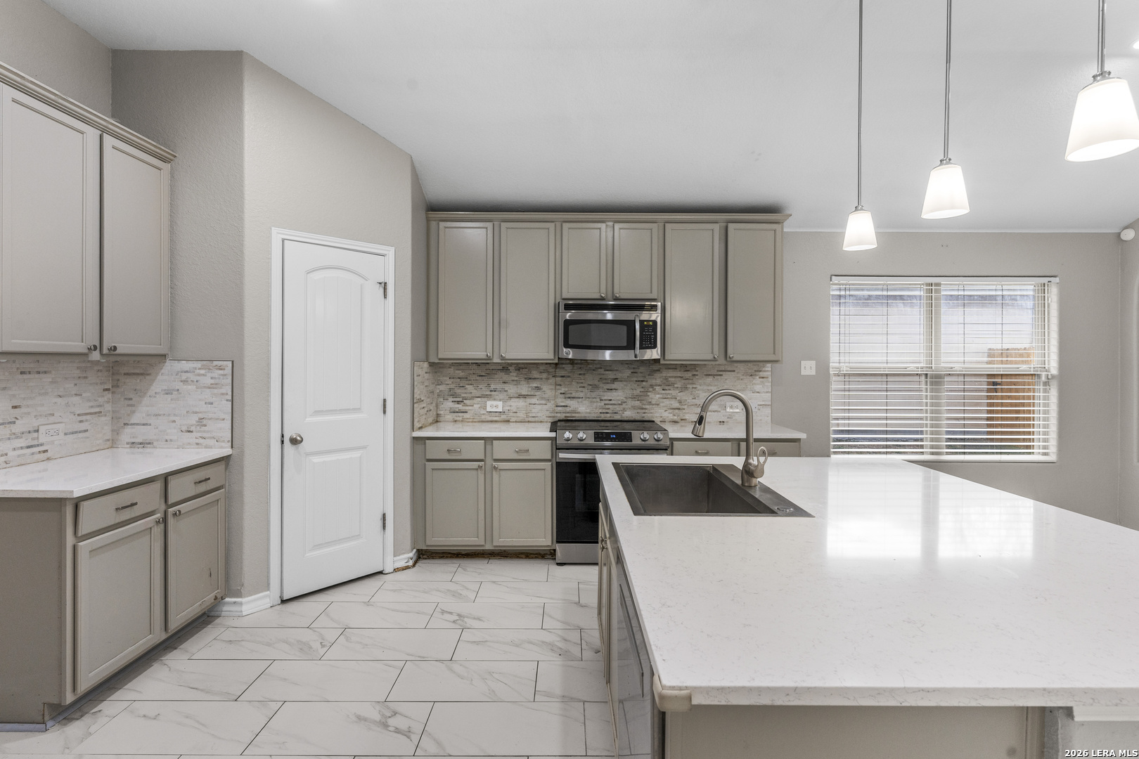10421 Macarthur Way Converse, TX 78109 - Photo 7 of 26 a large kitchen with cabinets and stainless steel appliances