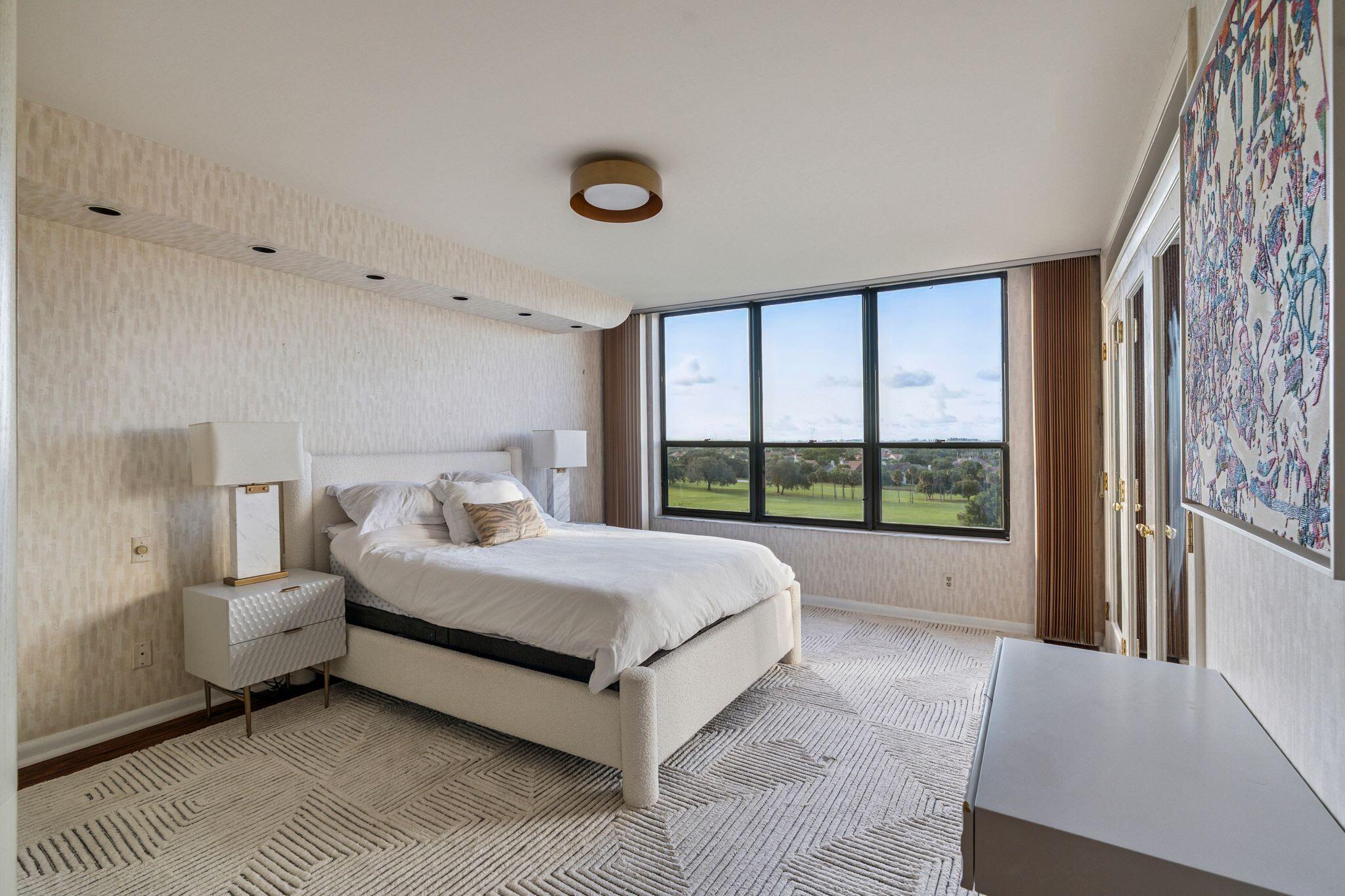 7217 Promenade Drive, Unit 801 Boca Raton, FL 33433 - Photo 21 of 39 a bed sitting in a spacious bedroom next to a window