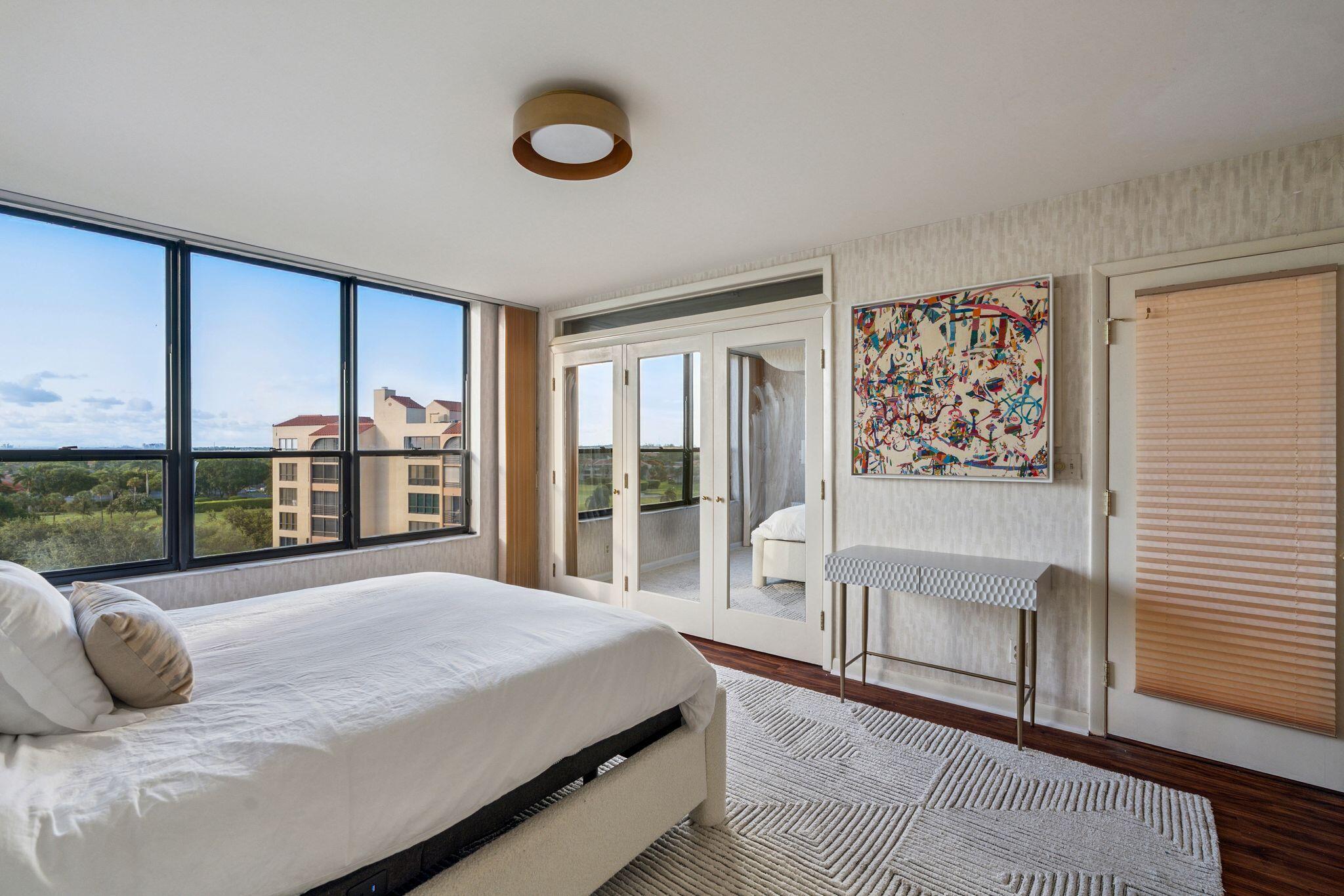 7217 Promenade Drive, Unit 801 Boca Raton, FL 33433 - Photo 22 of 39 a bedroom with a large bed and a large window