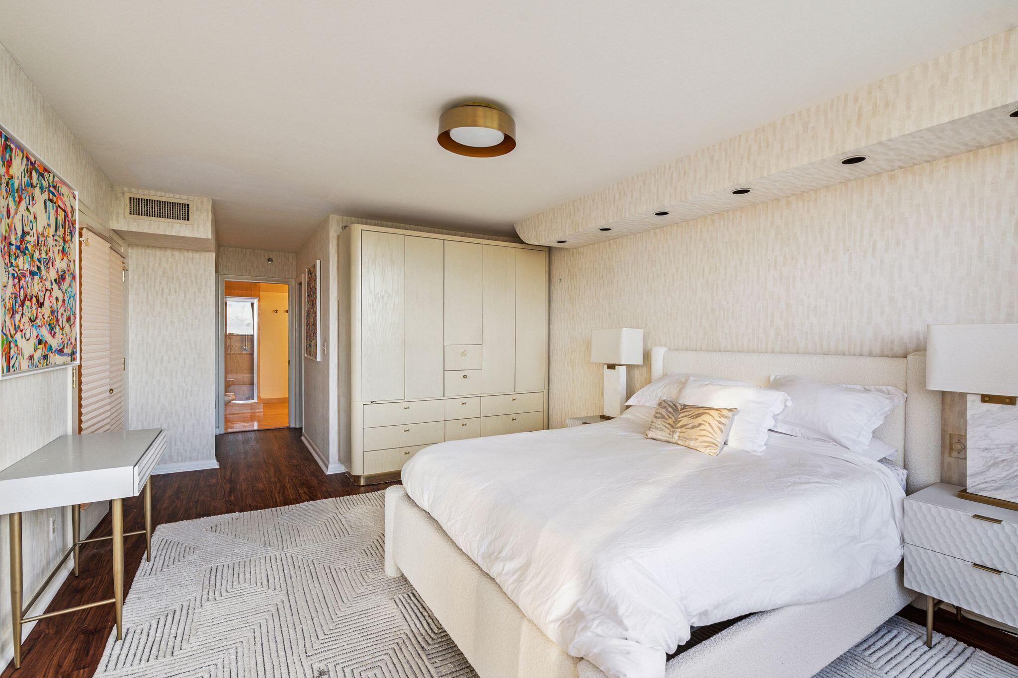 7217 Promenade Drive, Unit 801 Boca Raton, FL 33433 - Photo 23 of 39 a bedroom with a bed and a chandelier