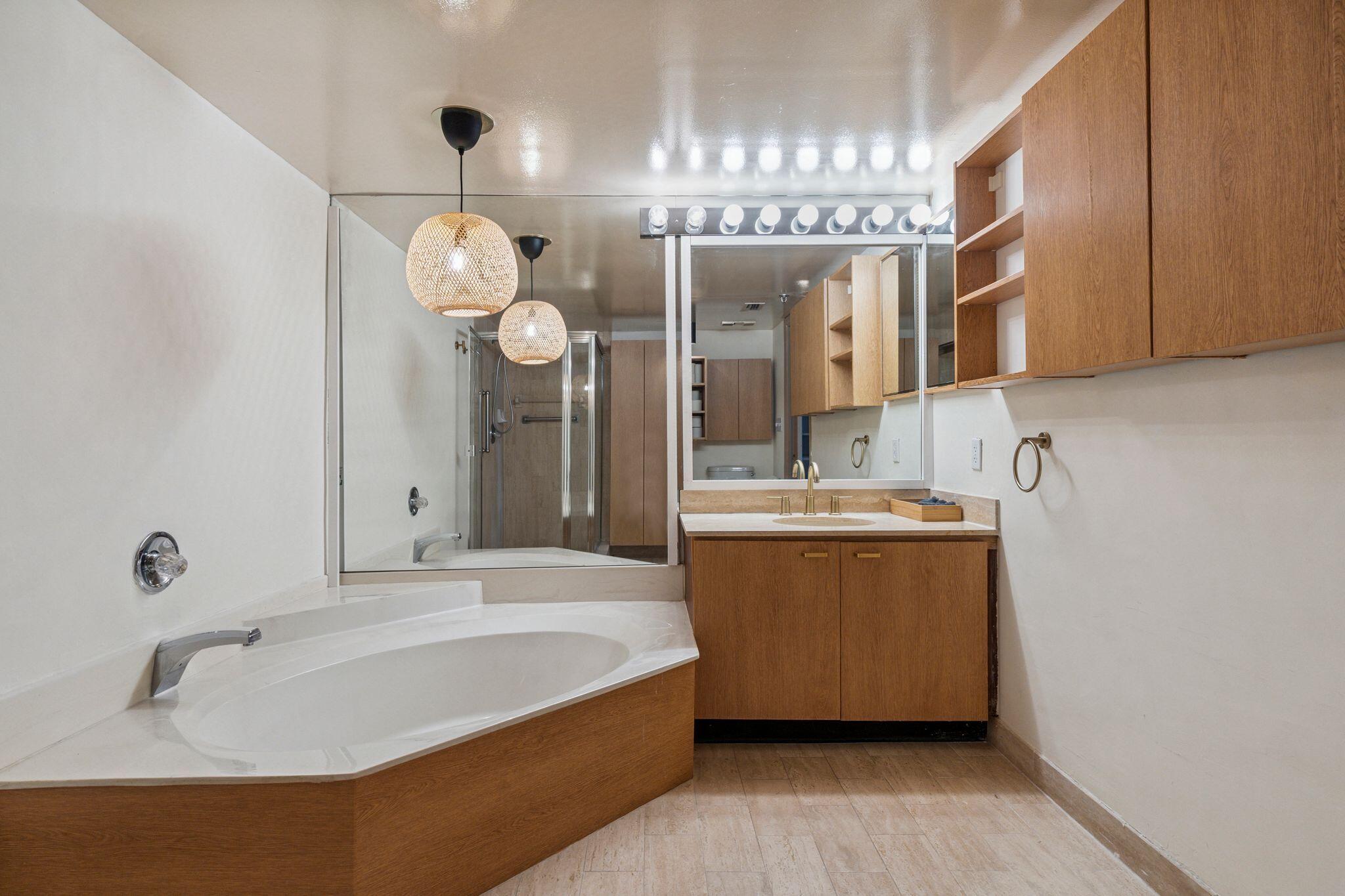 7217 Promenade Drive, Unit 801 Boca Raton, FL 33433 - Photo 26 of 39 a bathroom with a tub sink and mirror