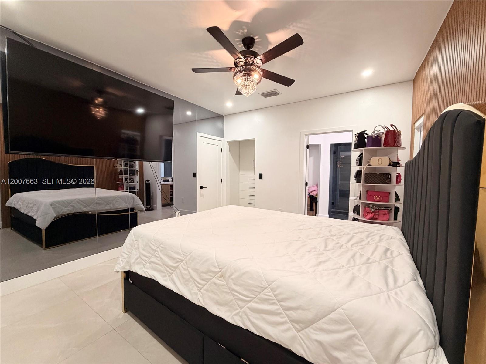 86 Northwest 4th Street Homestead, FL 33030 - Photo 11 of 22 a spacious bedroom with a bed and a ceiling fan