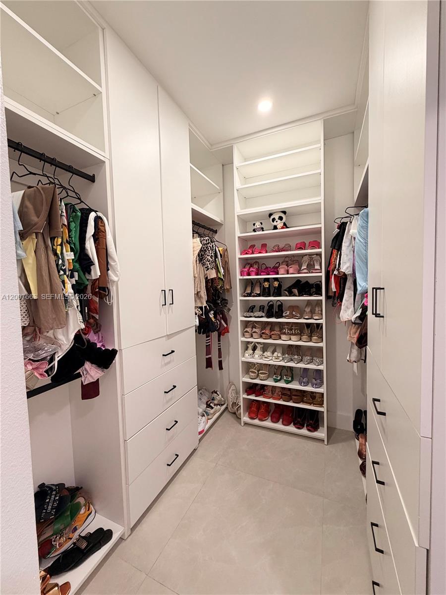 86 Northwest 4th Street Homestead, FL 33030 - Photo 14 of 22 a view of walk in closet with clothes and shoes