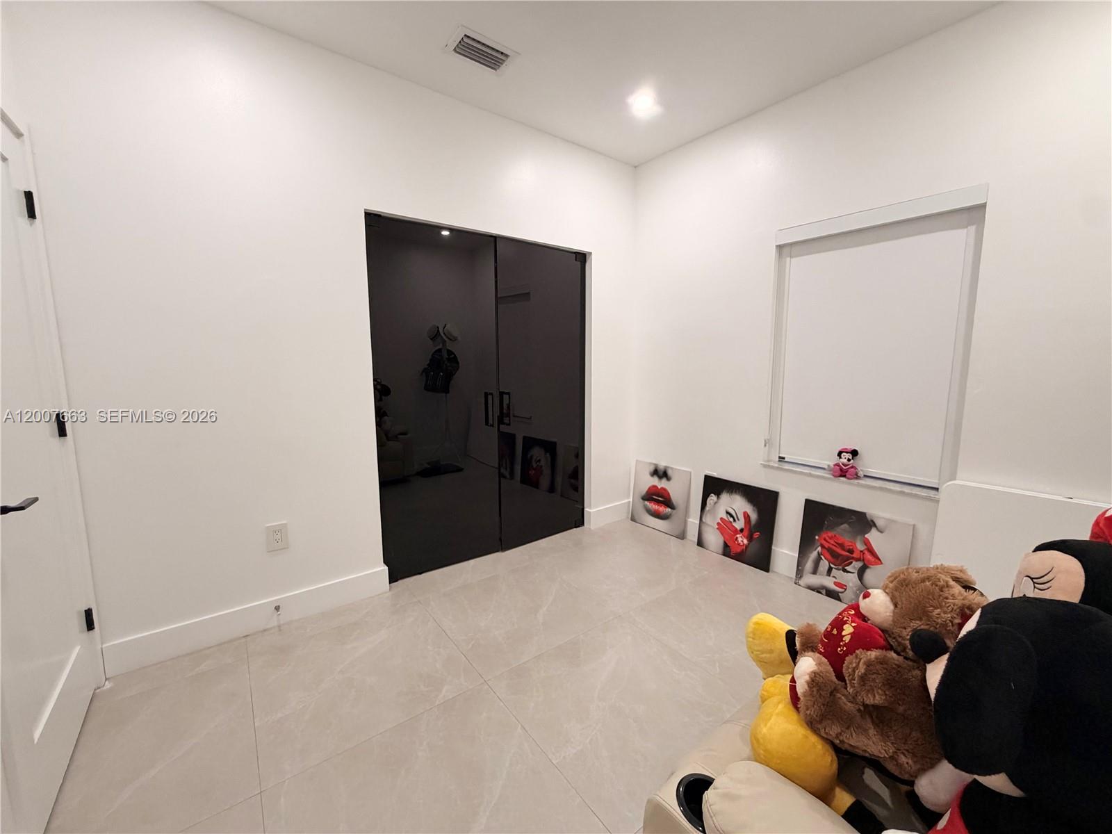 86 Northwest 4th Street Homestead, FL 33030 - Photo 17 of 22 a bedroom with a bed and a tv in it