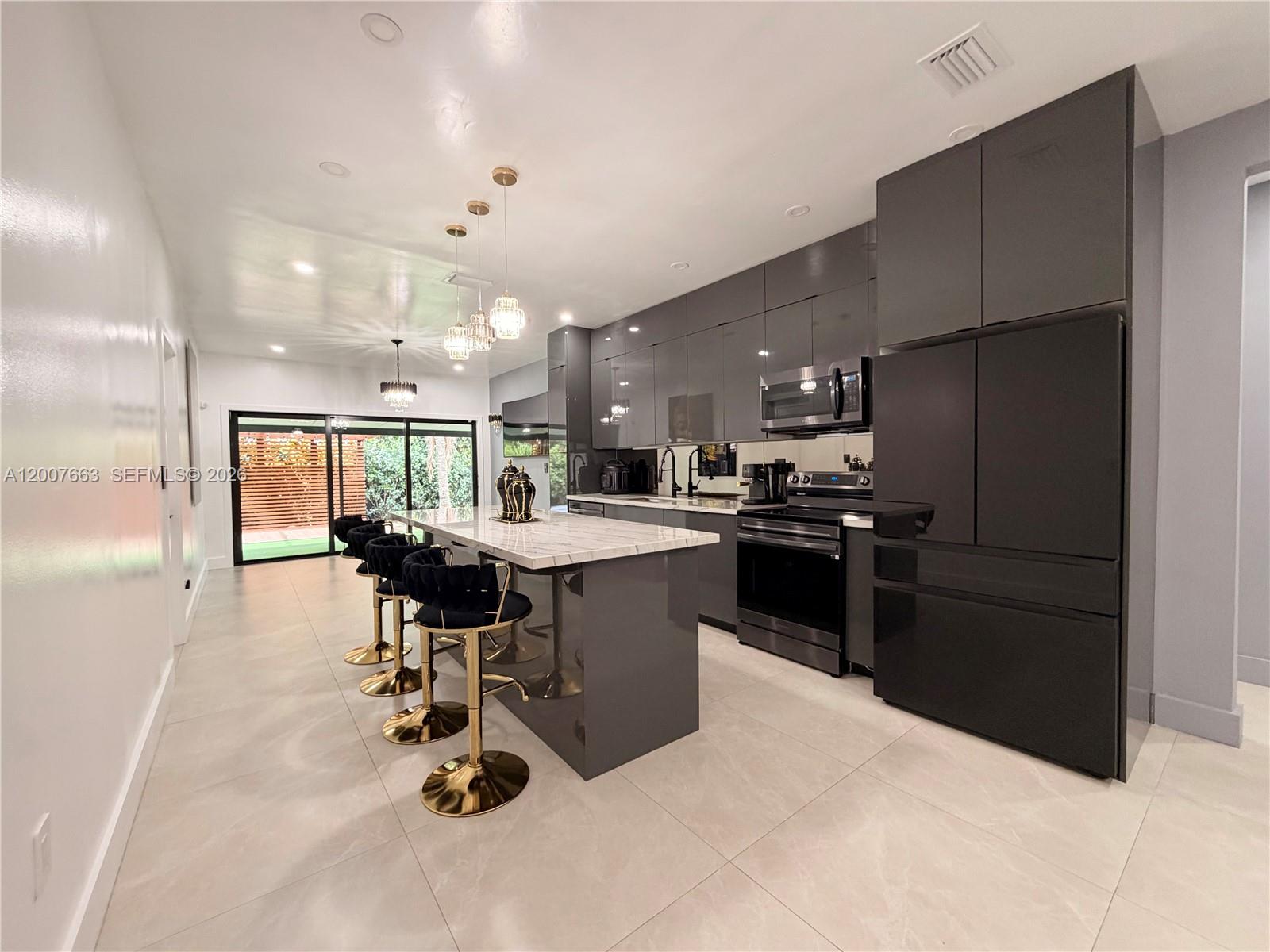 86 Northwest 4th Street Homestead, FL 33030 - Photo 6 of 22 a kitchen with a sink stainless steel appliances and cabinets