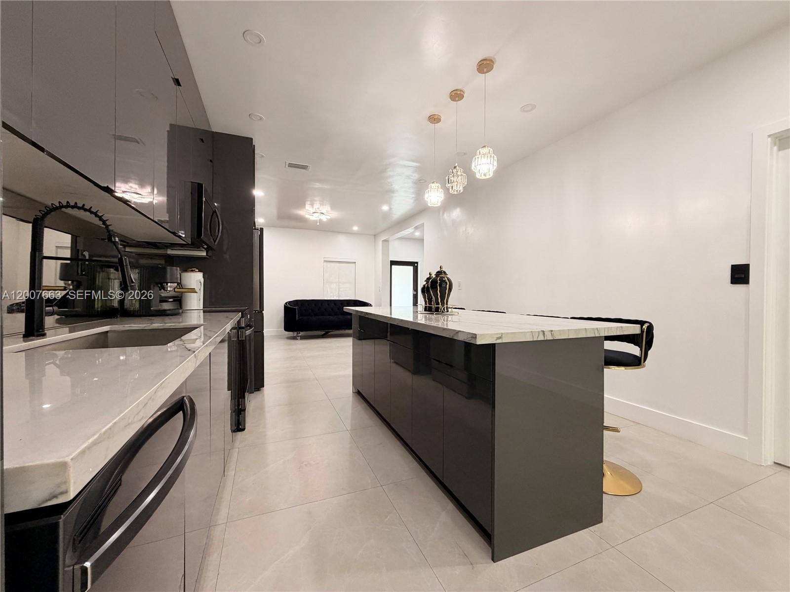 86 Northwest 4th Street Homestead, FL 33030 - Photo 9 of 22 a kitchen with kitchen island a sink counter top space and stainless steel appliances