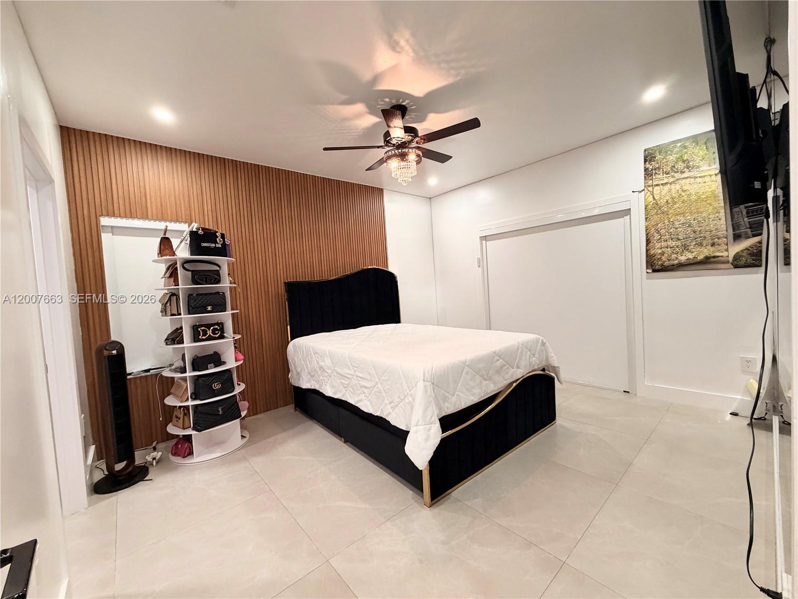 86 Northwest 4th Street Homestead, FL 33030 - Photo 10 of 22 a bedroom with a bed and a walk in closet