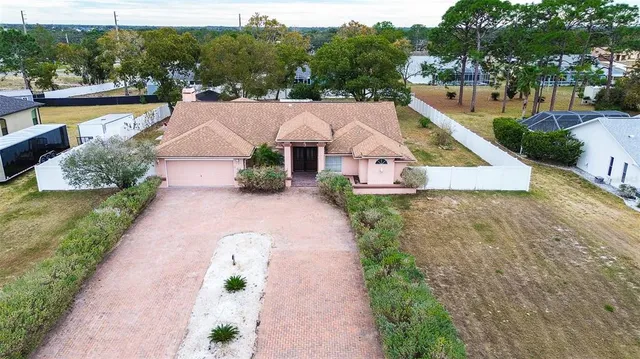 a view of an empty room with window and fireplace