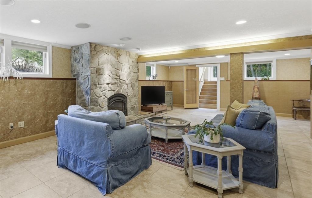 33 Labrie Lane Holyoke, MA 01040 - Photo 27 of 42 a living room with furniture a fireplace and a flat screen tv