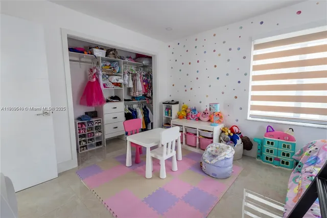 a bedroom with furniture and a window