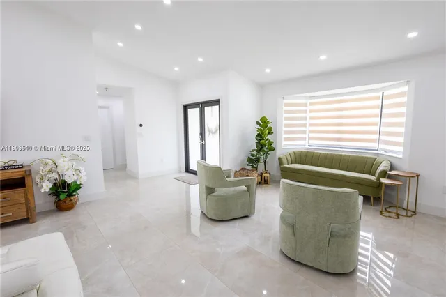 a living room with furniture and a potted plant