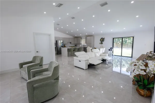 a living room with furniture and a potted plant