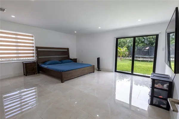 a living room with a window and a flat screen tv
