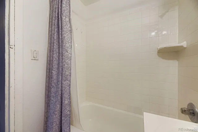 a bedroom with a bed couch and window