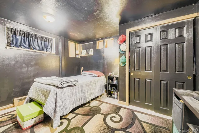 a backyard of a house with barbeque oven table and chairs