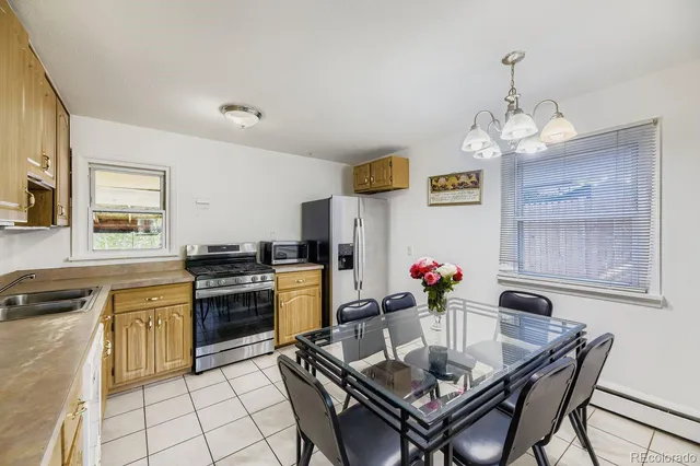a view of a dining room with furniture and a chandelier