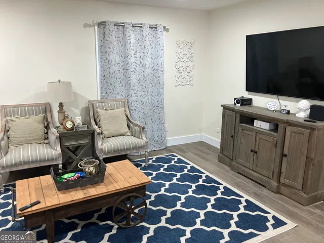 a living room with furniture and flat screen tv