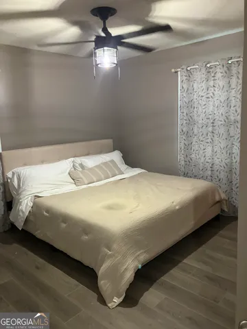 a large bed sitting in a bedroom next to a window