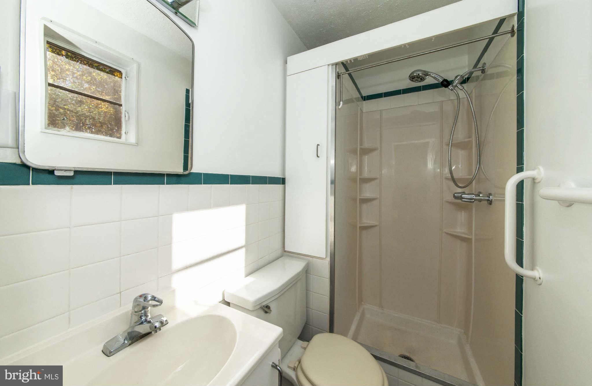 4014 Highview Drive Silver Spring, MD 20906 - Photo 15 of 22 a bathroom with a sink a toilet and shower