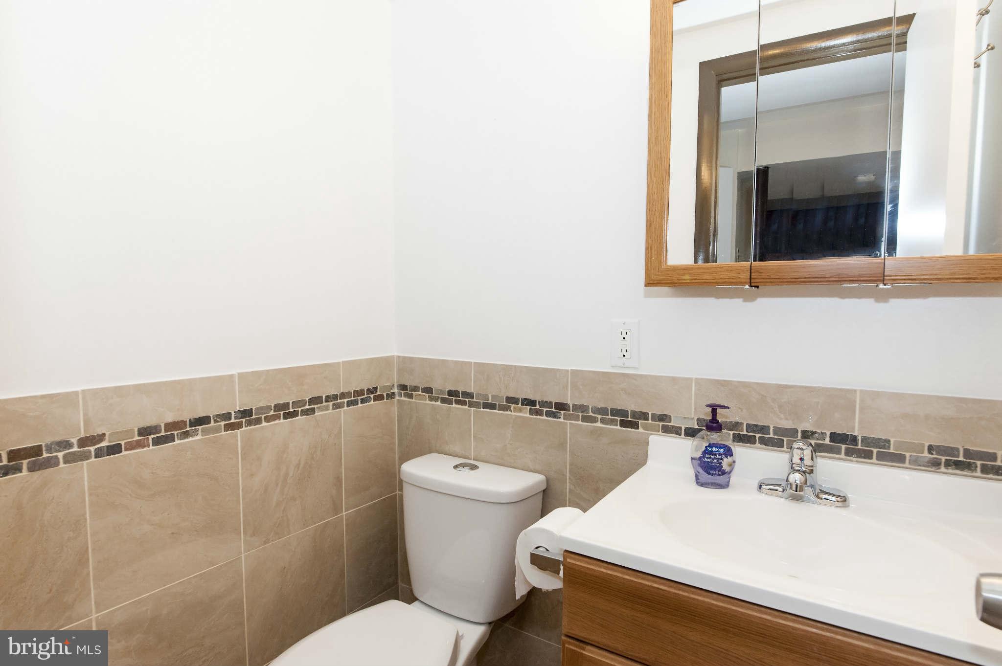 4014 Highview Drive Silver Spring, MD 20906 - Photo 19 of 22 a bathroom with a sink and a mirror
