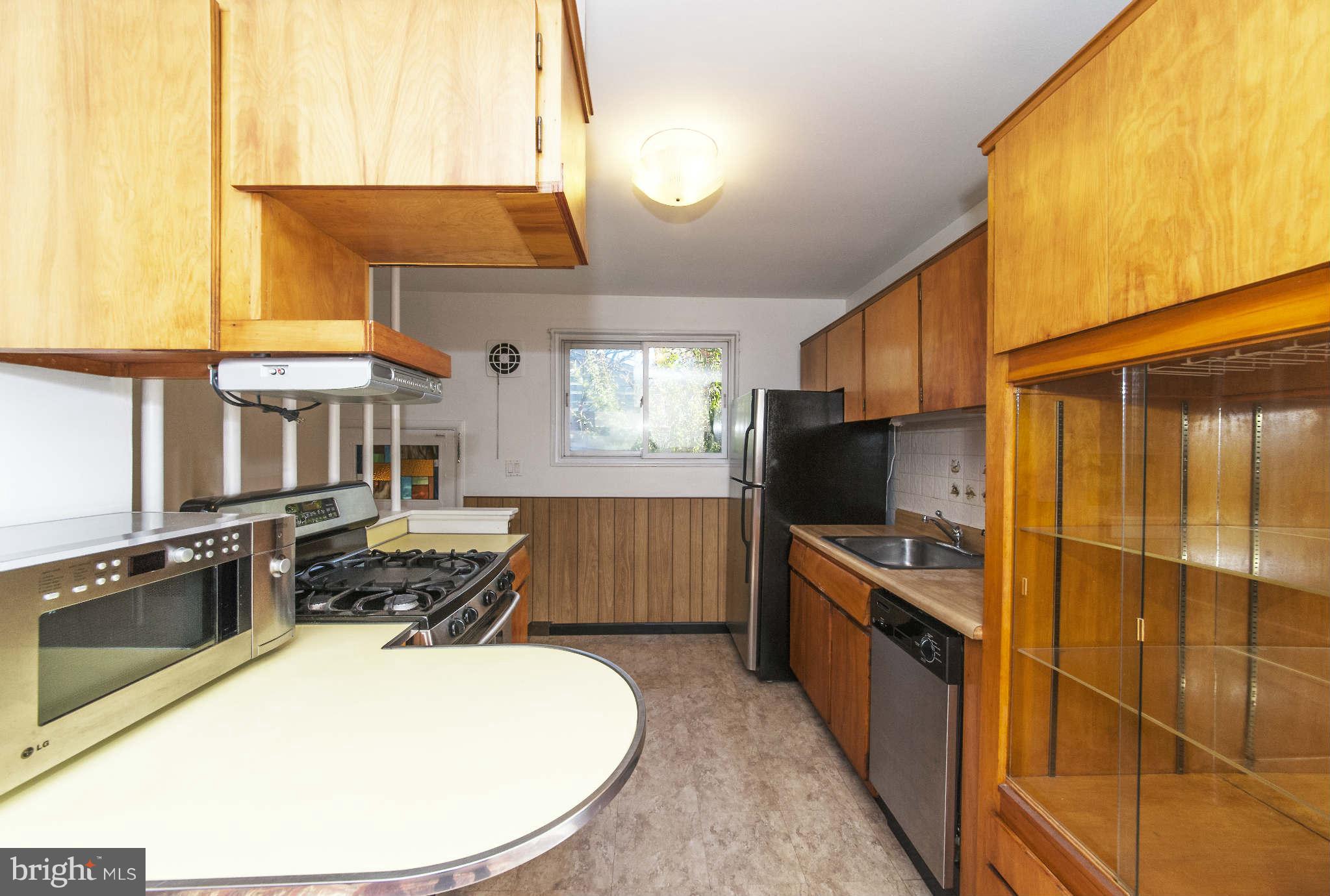 4014 Highview Drive Silver Spring, MD 20906 - Photo 8 of 22 a kitchen with a stove a sink and a microwave