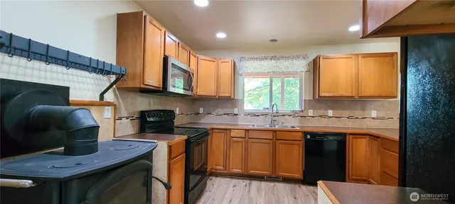 a kitchen with a sink cabinets and window