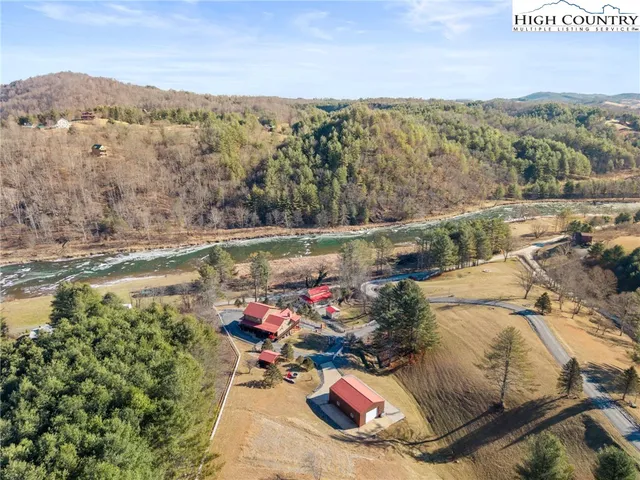 an aerial view of a house with a lake view