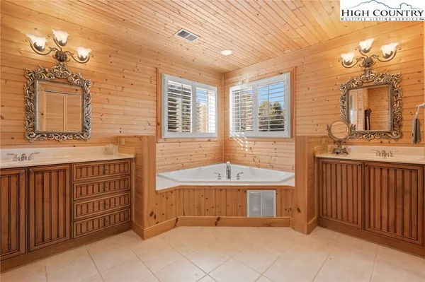 a bathroom with a tub sink and mirror