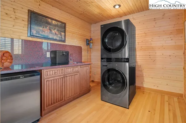 a large bedroom with a bed and wooden floor