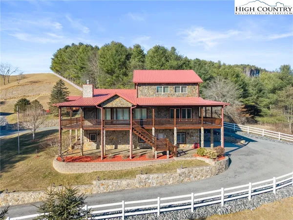 a view of a house with a swimming pool and sitting area
