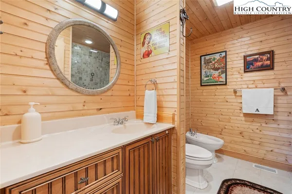 a kitchen with stainless steel appliances granite countertop a sink a stove and wooden cabinets