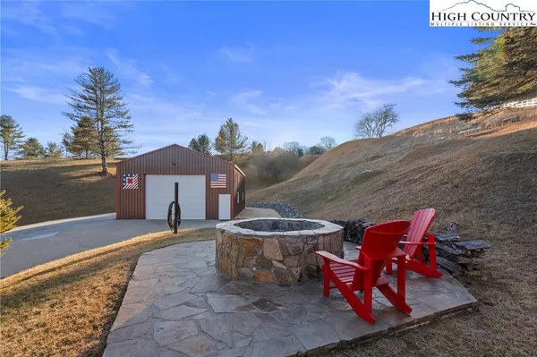 an outdoor space with seating area and barbeque oven