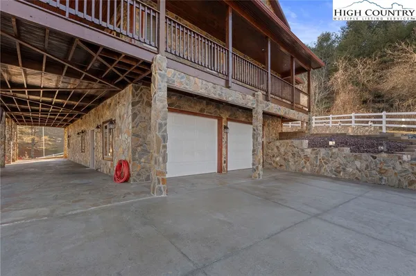 an aerial view of a house with a yard basket ball court and outdoor seating