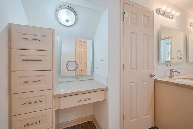 a spacious bathroom with a double vanity sink mirror and shower