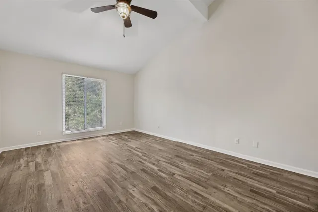 wooden floor in an empty room with a window
