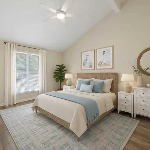 a bedroom with a large bed and a chandelier