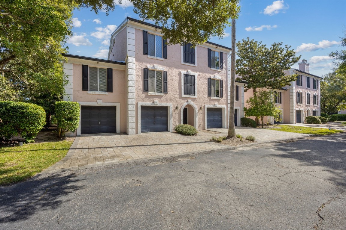 4734 Gulf Stream Court, Unit 9 Fernandina Beach, FL 32034 - Photo 2 of 32 a front view of a house with a yard and palm trees