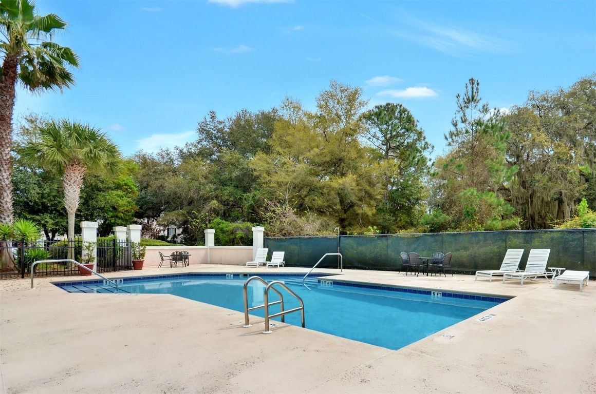 4734 Gulf Stream Court, Unit 9 Fernandina Beach, FL 32034 - Photo 31 of 32 a view of a swimming pool with a patio and a yard