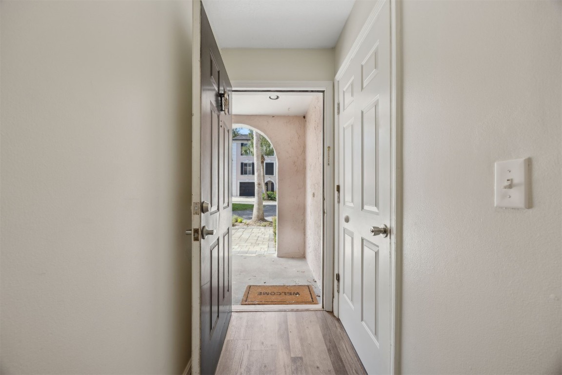 4734 Gulf Stream Court, Unit 9 Fernandina Beach, FL 32034 - Photo 6 of 32 a view of a hallway with wooden floor and staircase