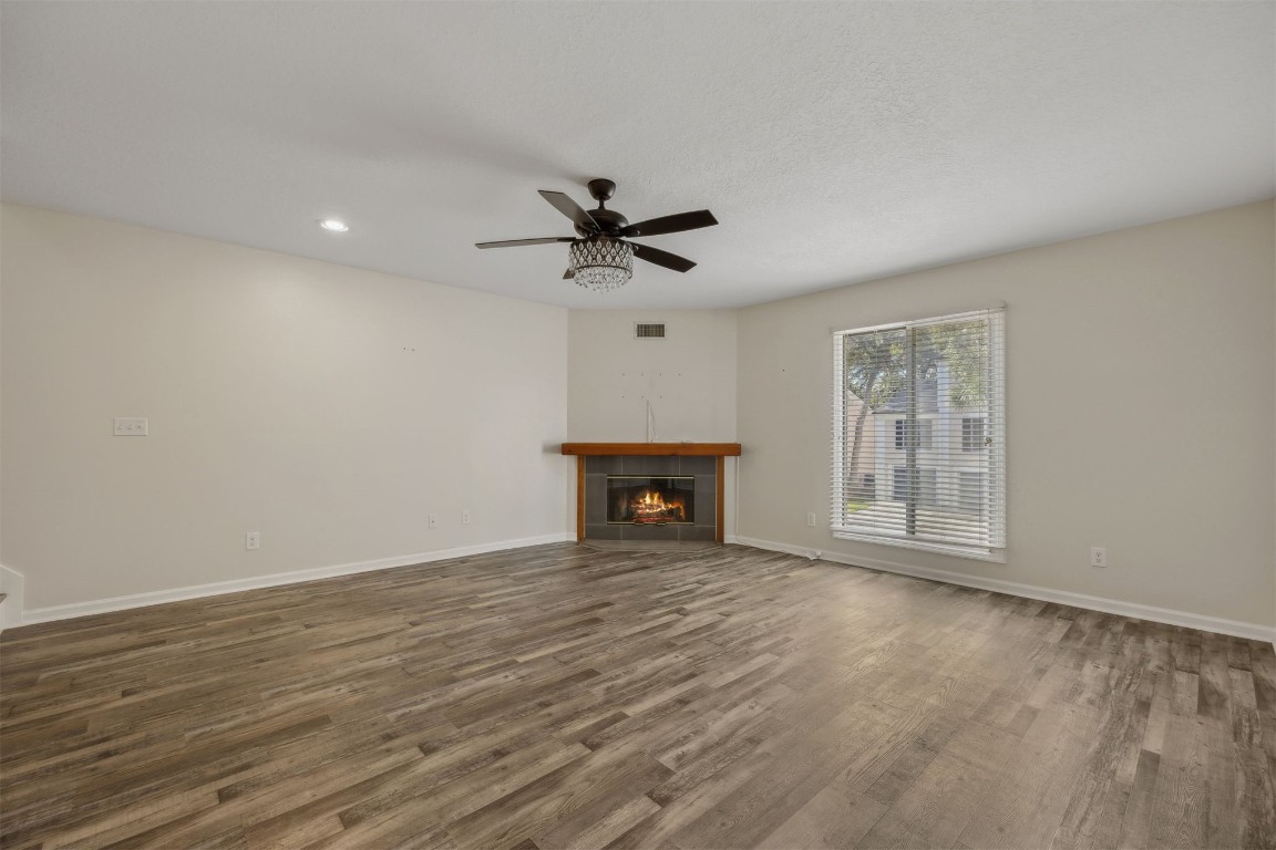 4734 Gulf Stream Court, Unit 9 Fernandina Beach, FL 32034 - Photo 10 of 32 a view of an empty room with a fireplace and a window