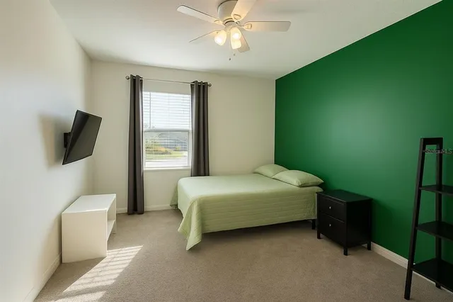 a bedroom with a bed a couch and a window