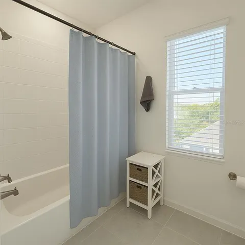 a bathroom with a window and a shower