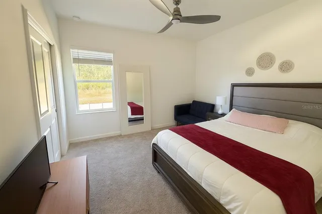 a bedroom with a bed and a window