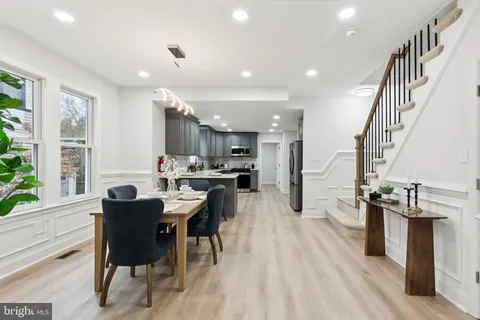 a view of a dining room with furniture and a potted plant