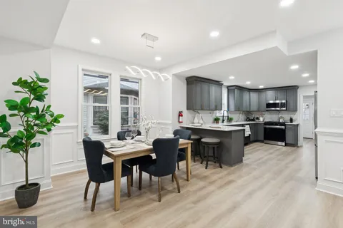 a kitchen with stainless steel appliances kitchen island granite countertop a sink and a stove