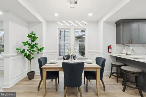 a kitchen with stainless steel appliances kitchen island granite countertop a sink refrigerator and cabinets